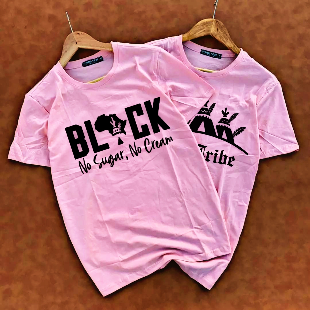 Two pink Mi-Tribe graphic T-shirts on wooden hangers